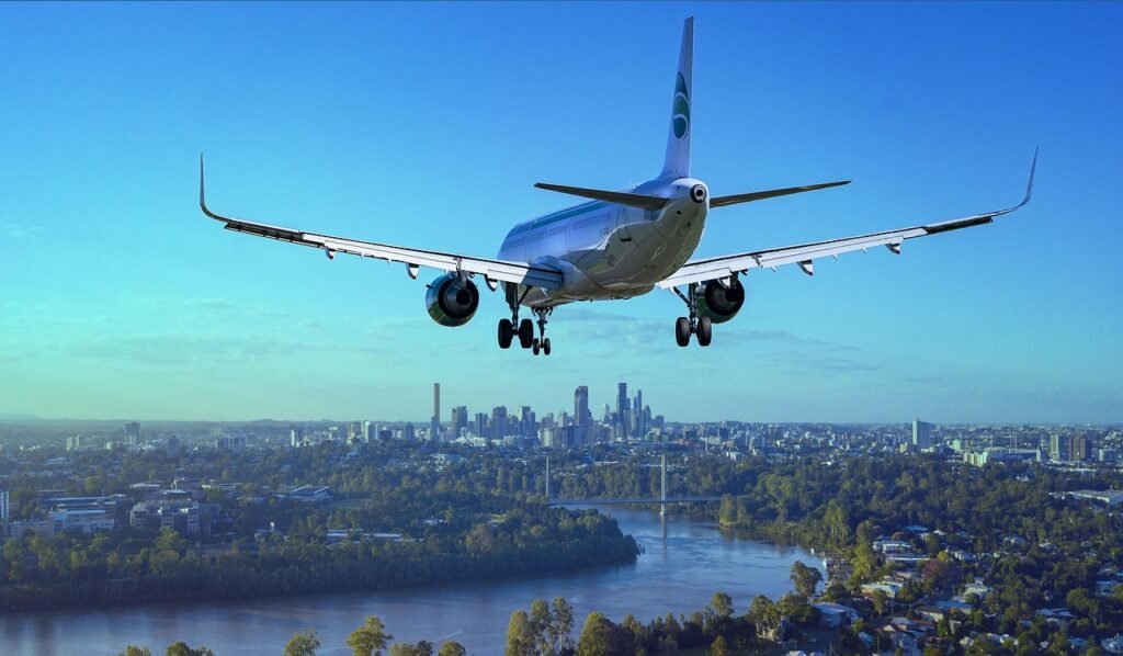 airplane, flight, city, landing, river, boeing, aircraft, plane, travel, flying, nature, sky, passenger aircraft, airliner, aviation, arrival, transport, skyscrapers, urban