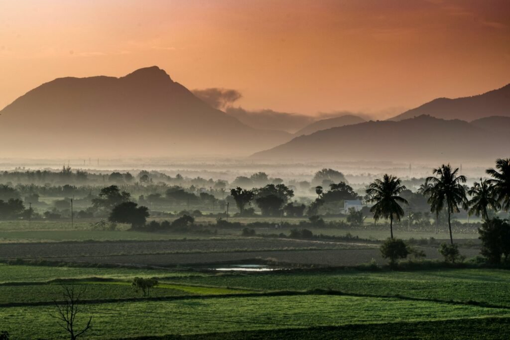 green grass field near mountain during daytime