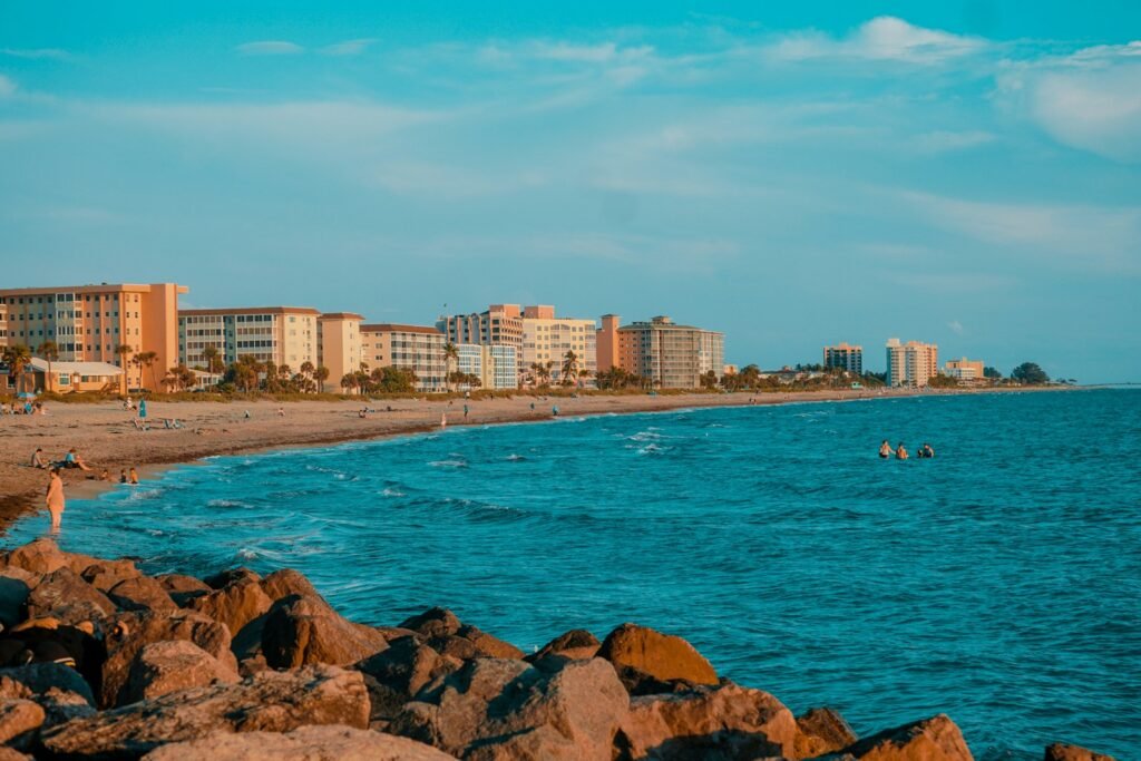 a man standing on a beach next to a body of water