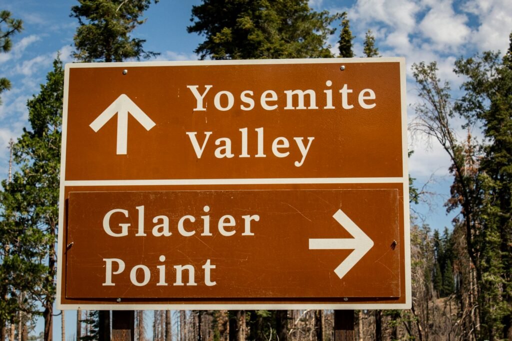 a close up of a street sign with trees in the background