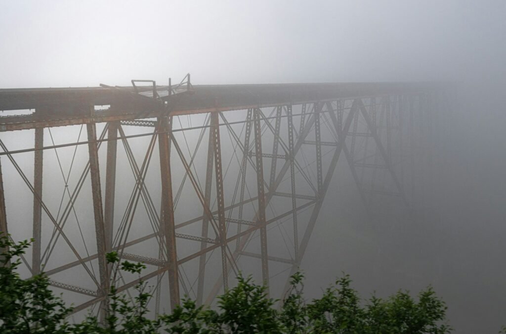 A foggy view of a large bridge over a body of water