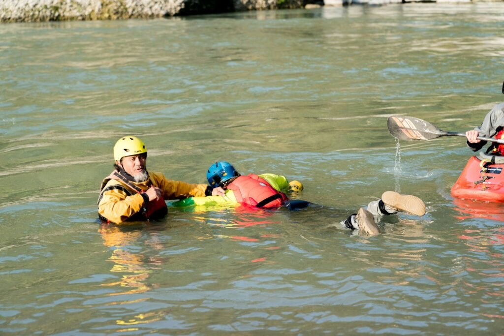 A man in a kayak and a dog in the water