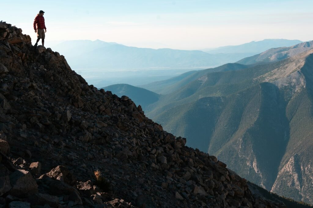 A man standing on top of a rocky mountain