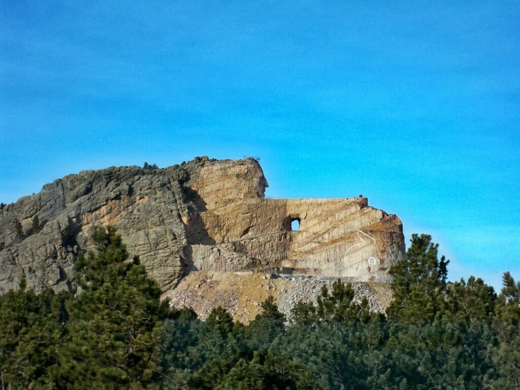 Majestic view of Crazy Horse Memorial against a clear blue sky.