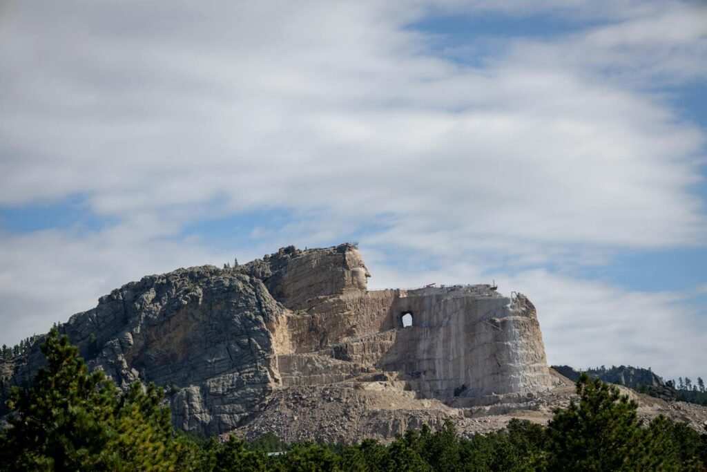 A breathtaking view of the Crazy Horse Memorial against a bright blue sky in South Dakota.