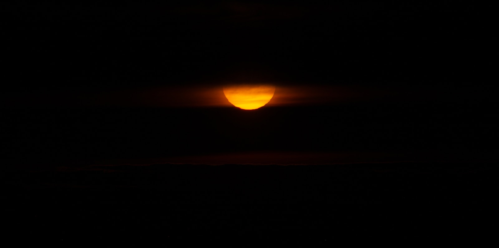 the sun is shining brightly in the dark sky