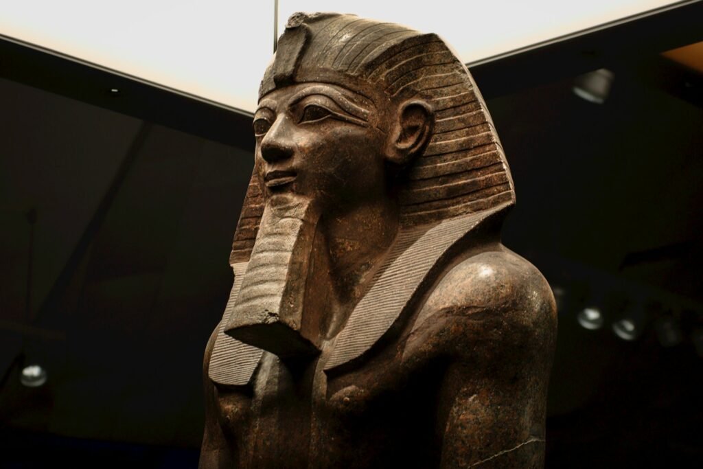 Ancient egyptian pharaoh statue with nemes headdress