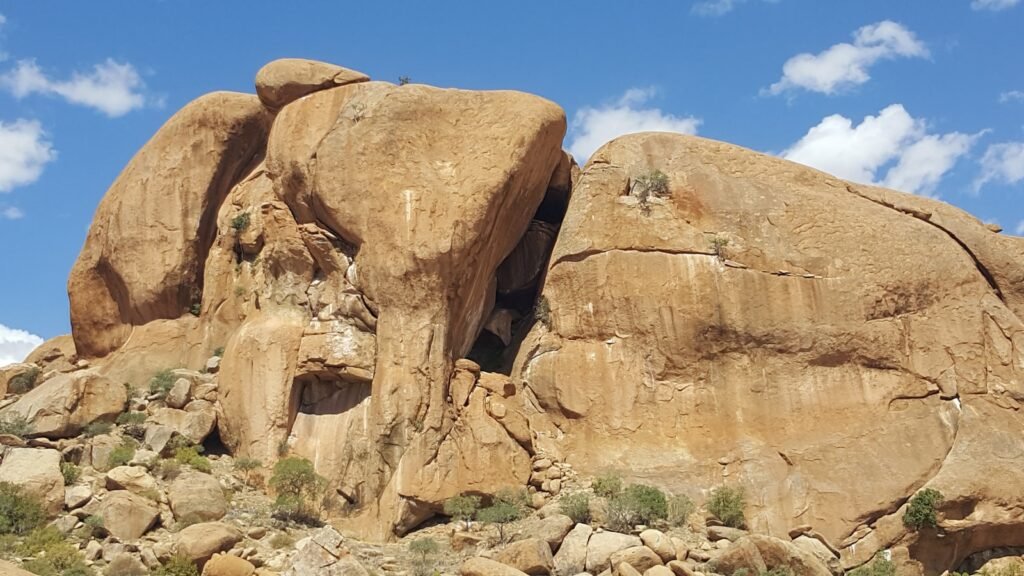 a large rock formation in the middle of a desert