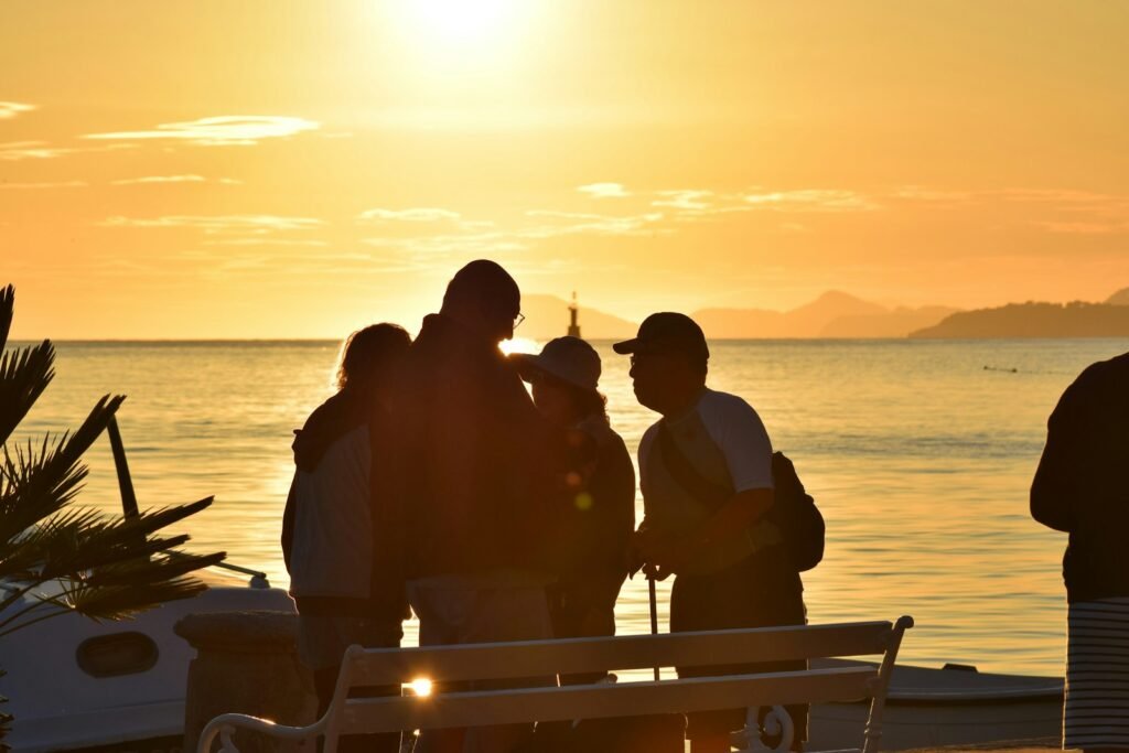 silhouette of people sitting on boat during sunset