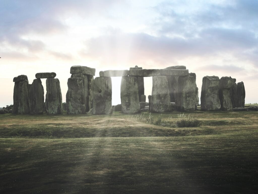 A group of stonehenge standing in a field