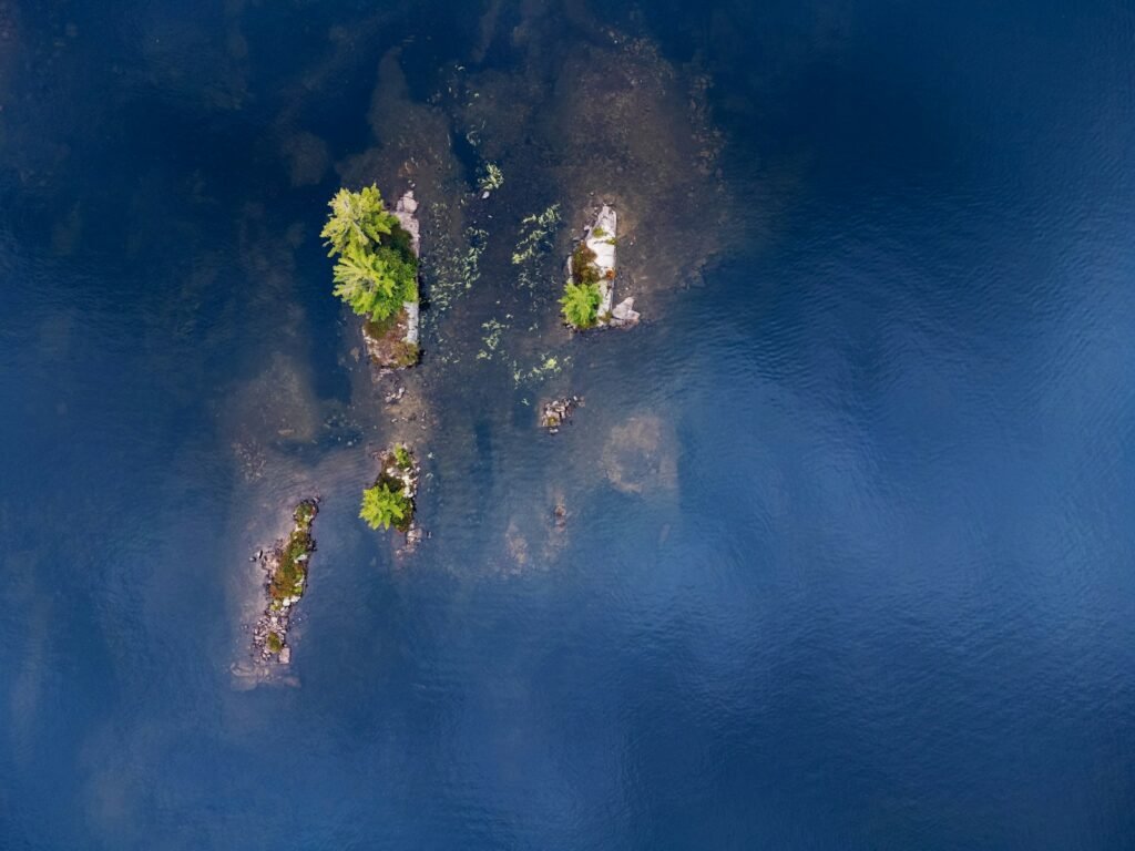 Small islands with trees in deep blue water
