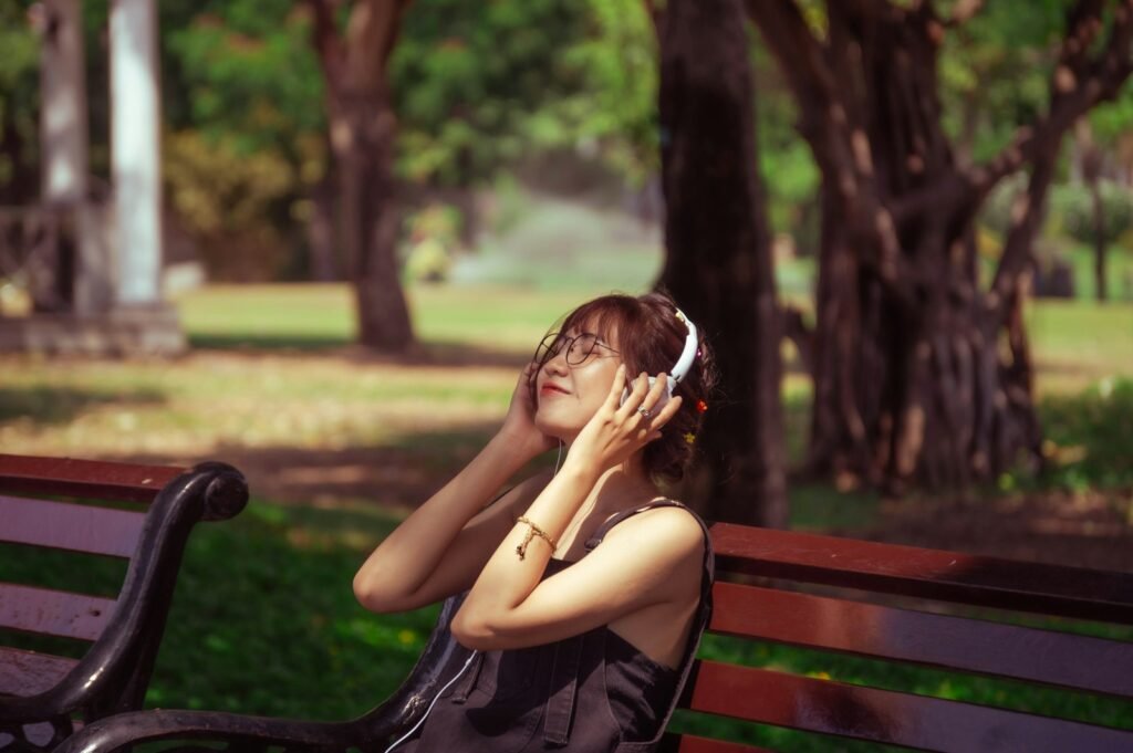 a woman sitting on a bench talking on a cell phone