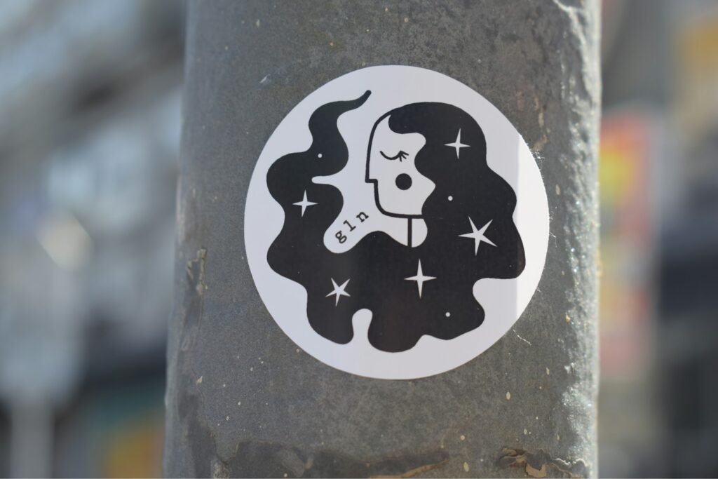 a sticker of a woman's face on a pole